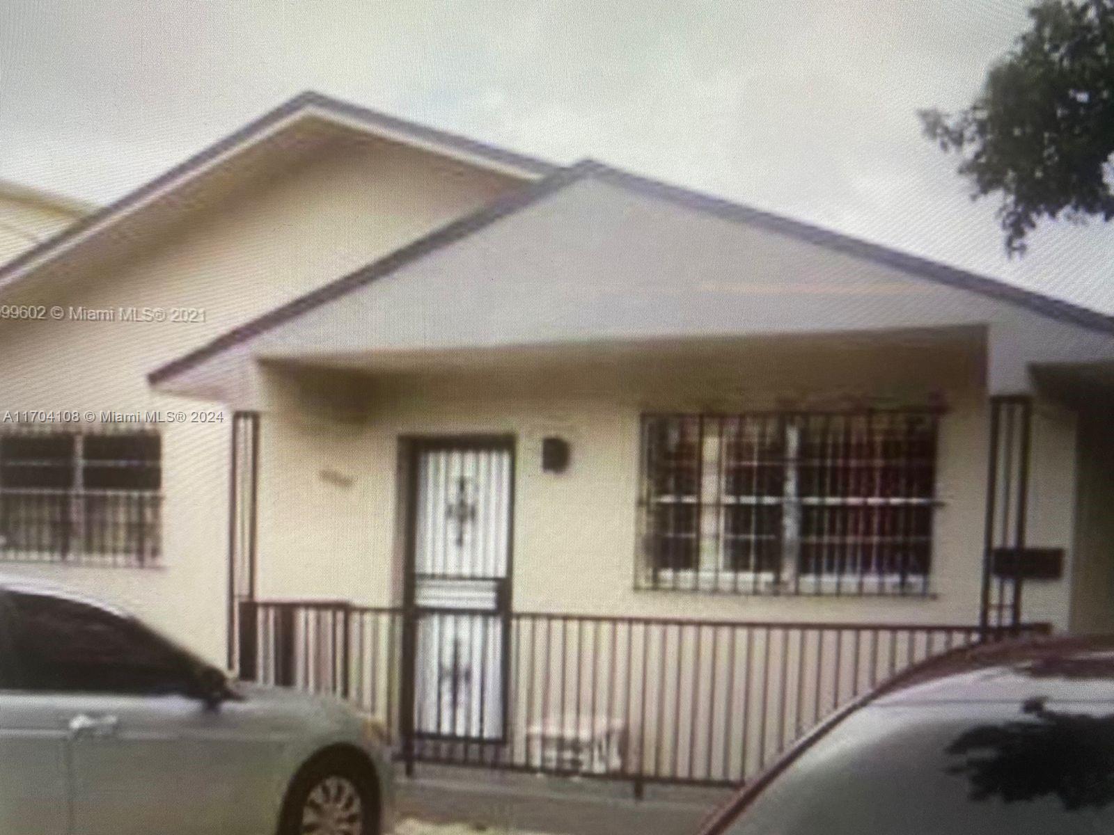 a view of a car parked front of a house