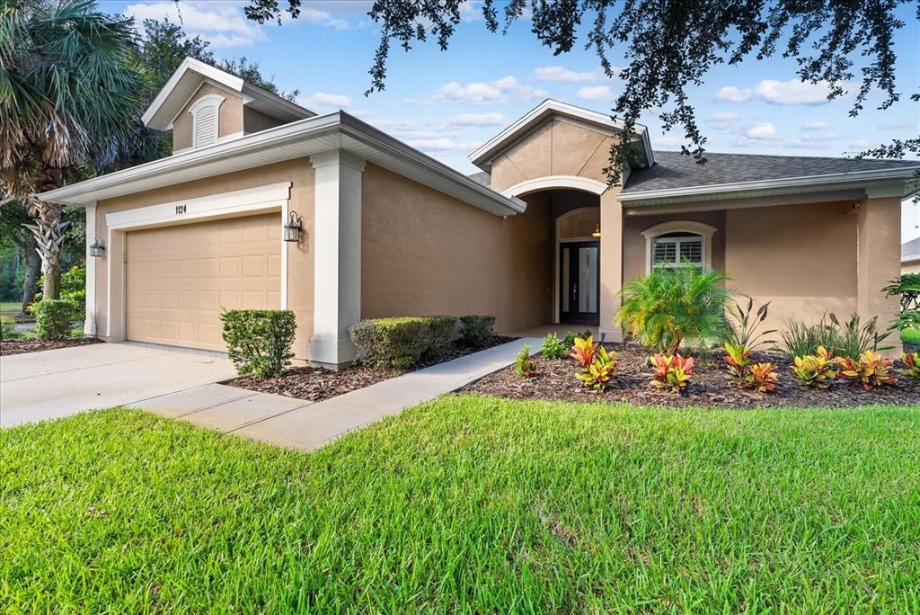 a front view of a house with a yard and garage