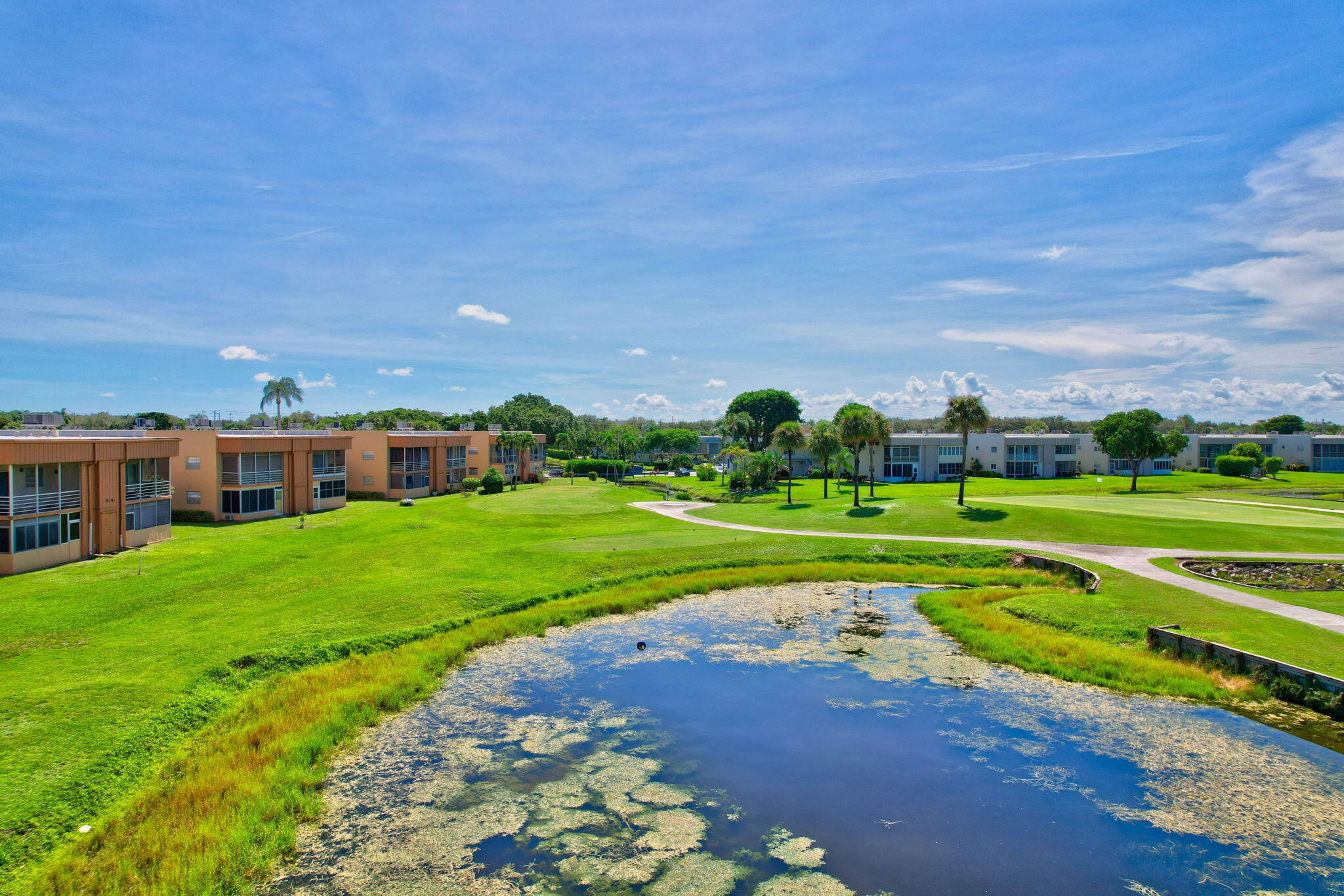 a view of a big house with a big yard