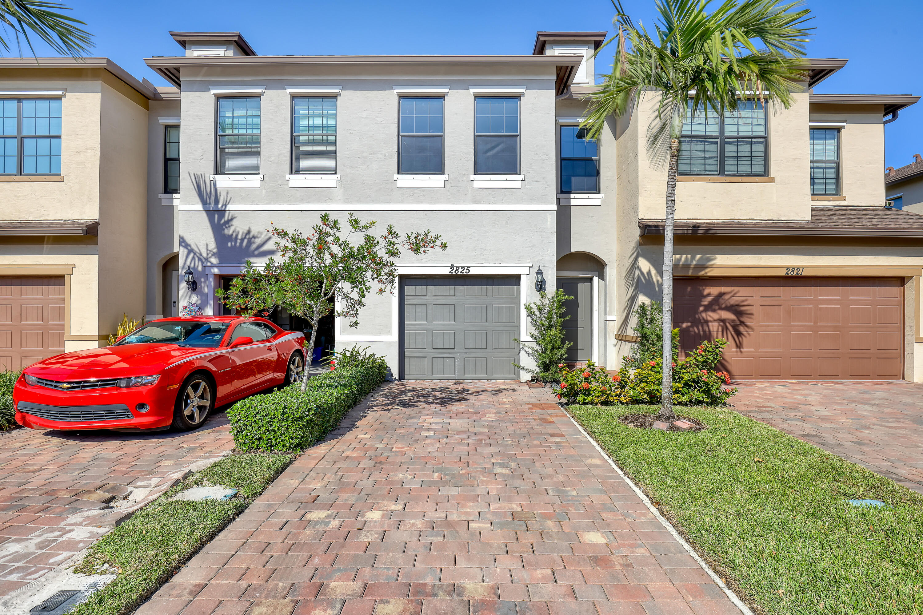 a front view of a house with a yard and garage