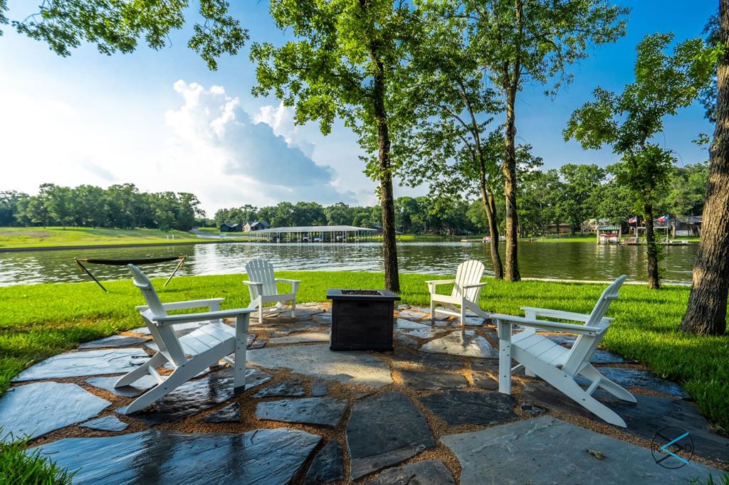 an outdoor sitting area with lake view