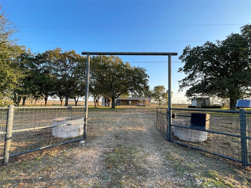 a view of a yard with wooden fence