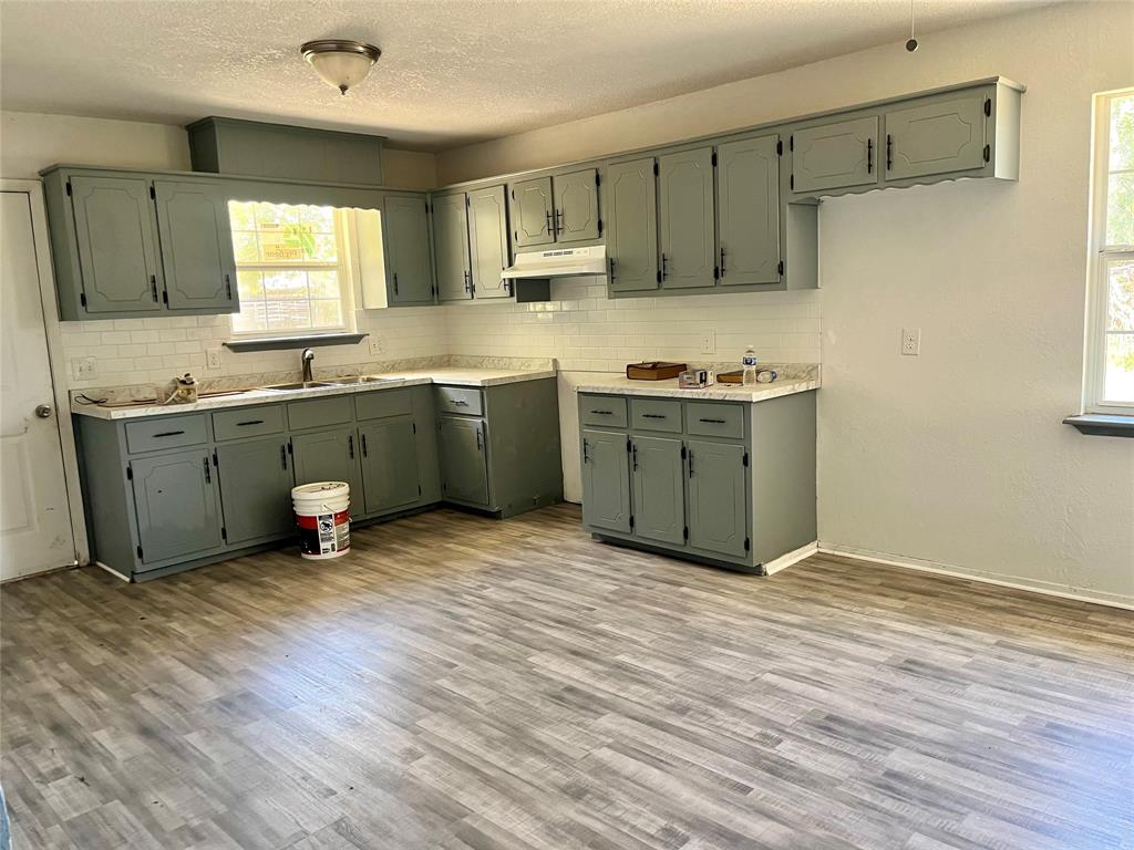 a kitchen with sink cabinets and window