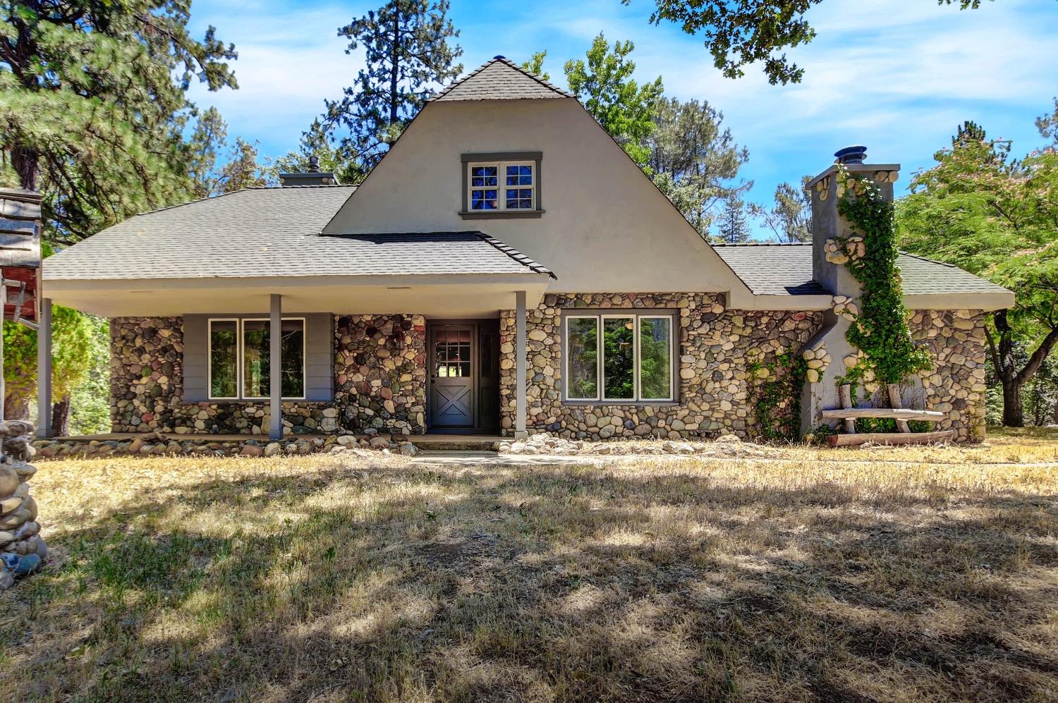 a front view of a house with a garden