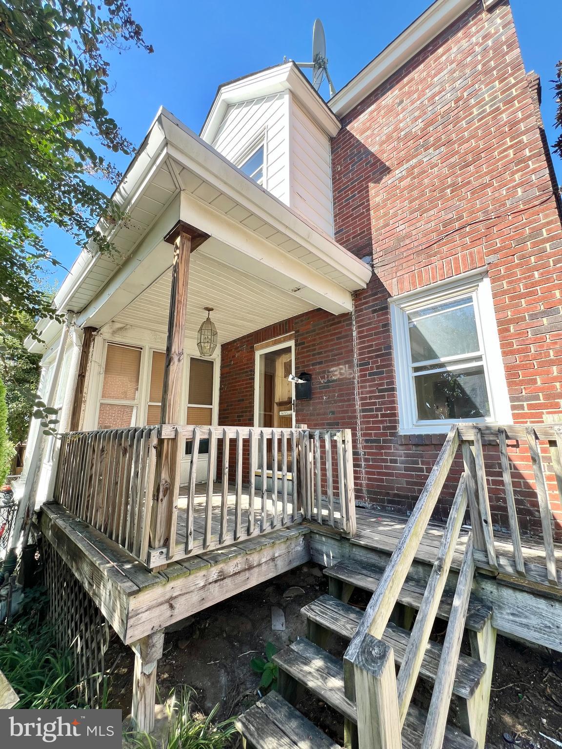 a view of a house with wooden deck and furniture