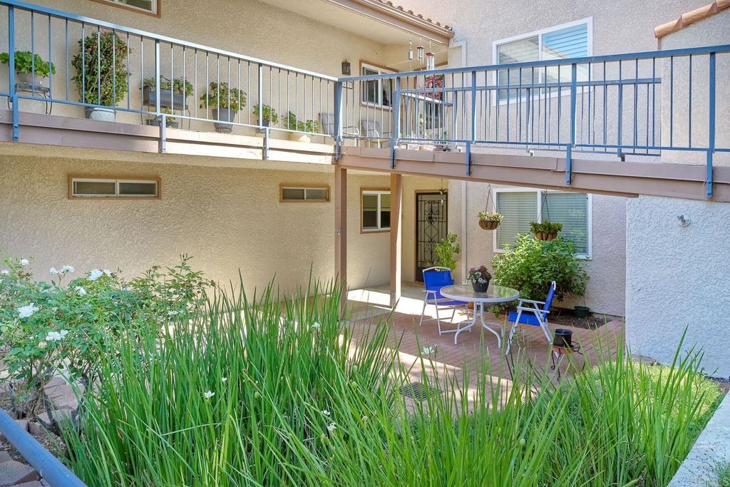 a view of a house with backyard and sitting area