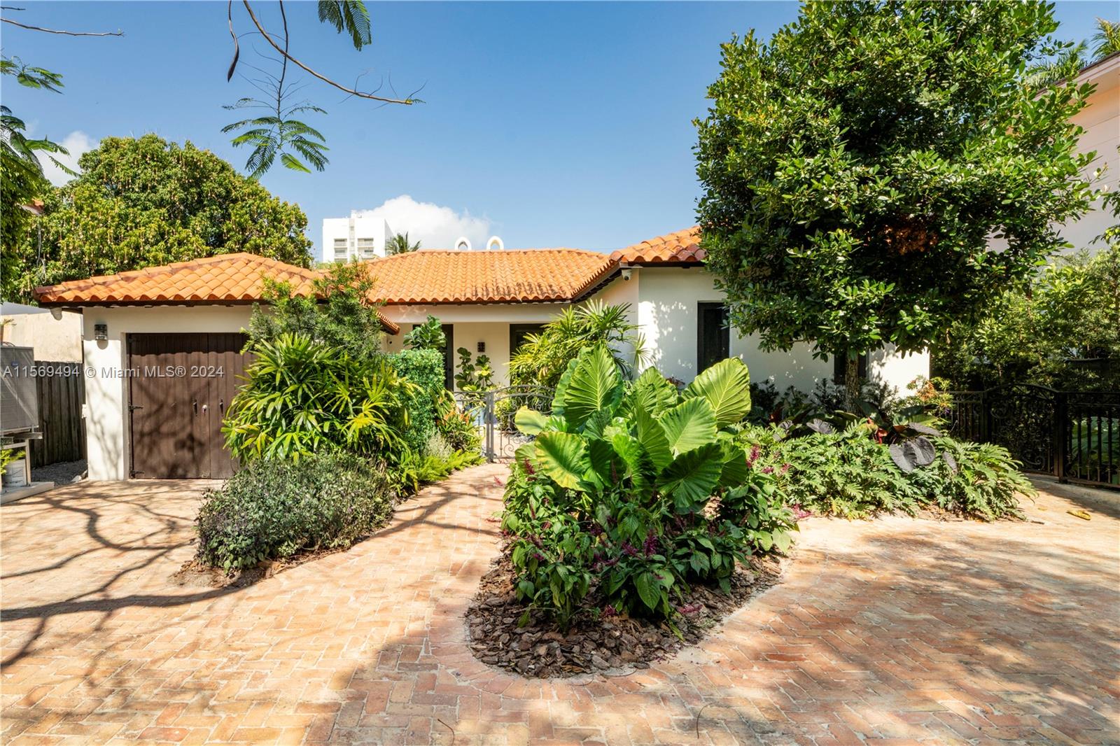 a view of a house with a yard and garden