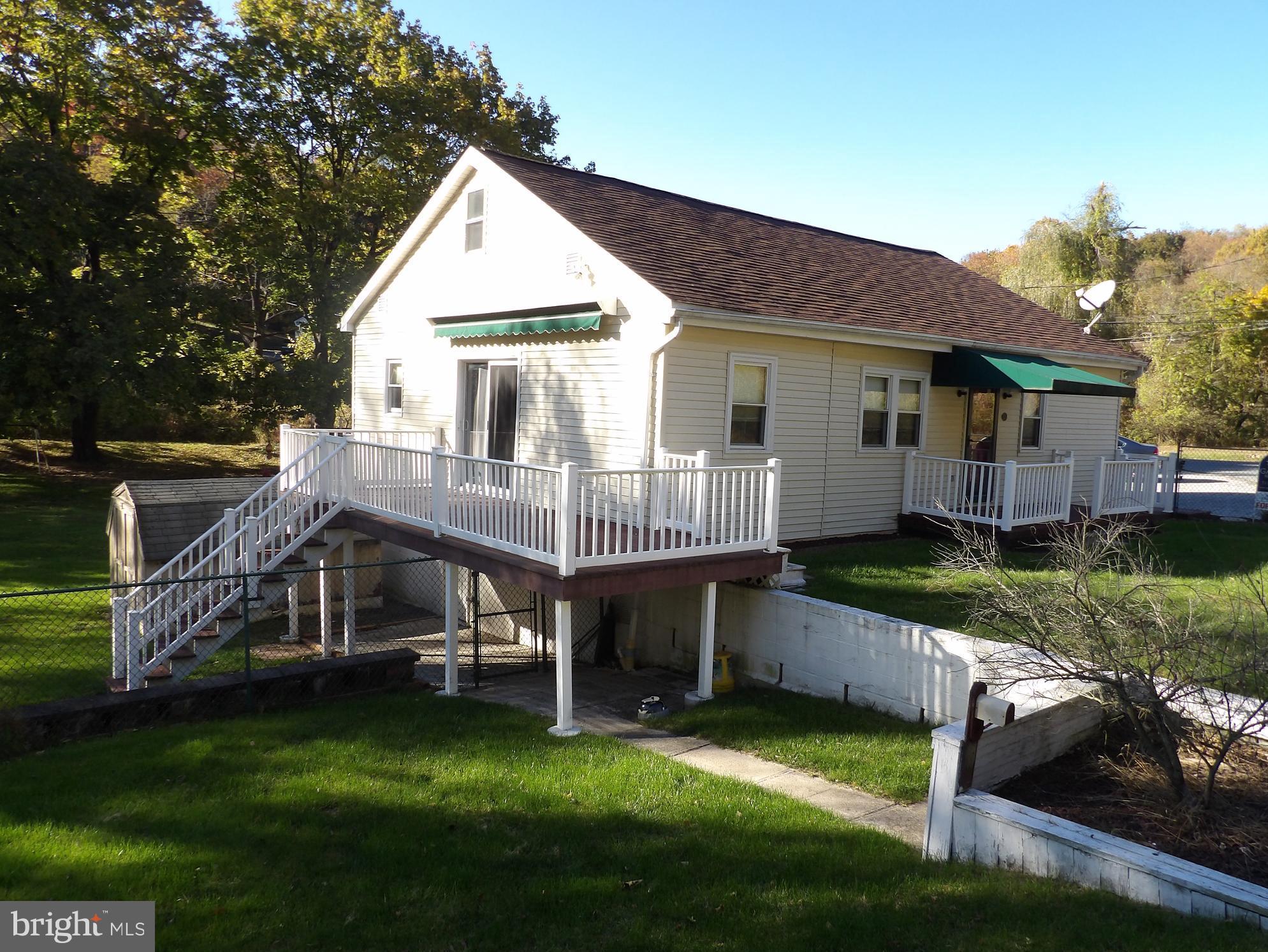 a view of a house with a yard patio and sitting area