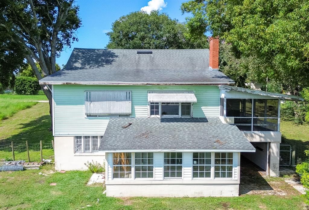 a aerial view of a house with a yard and potted plants