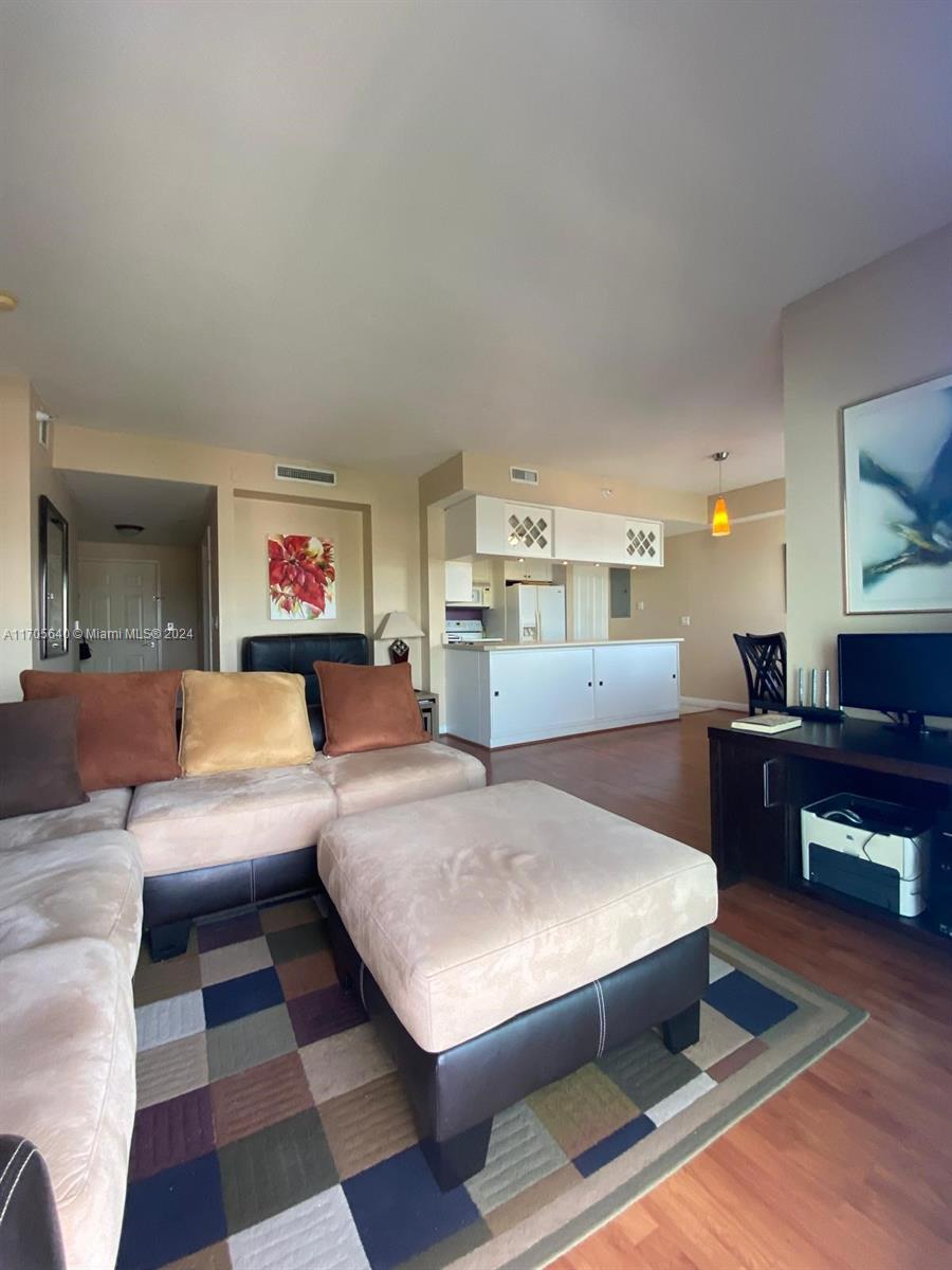 a living room with furniture and a piano