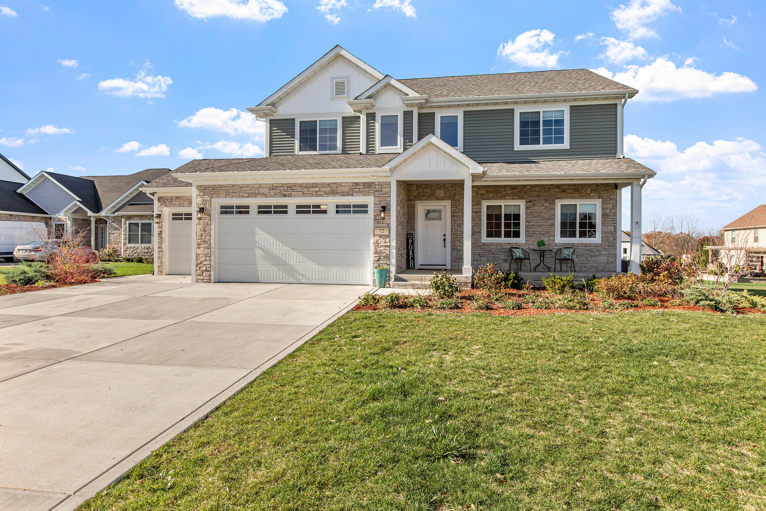 a front view of a house with yard porch and outdoor seating