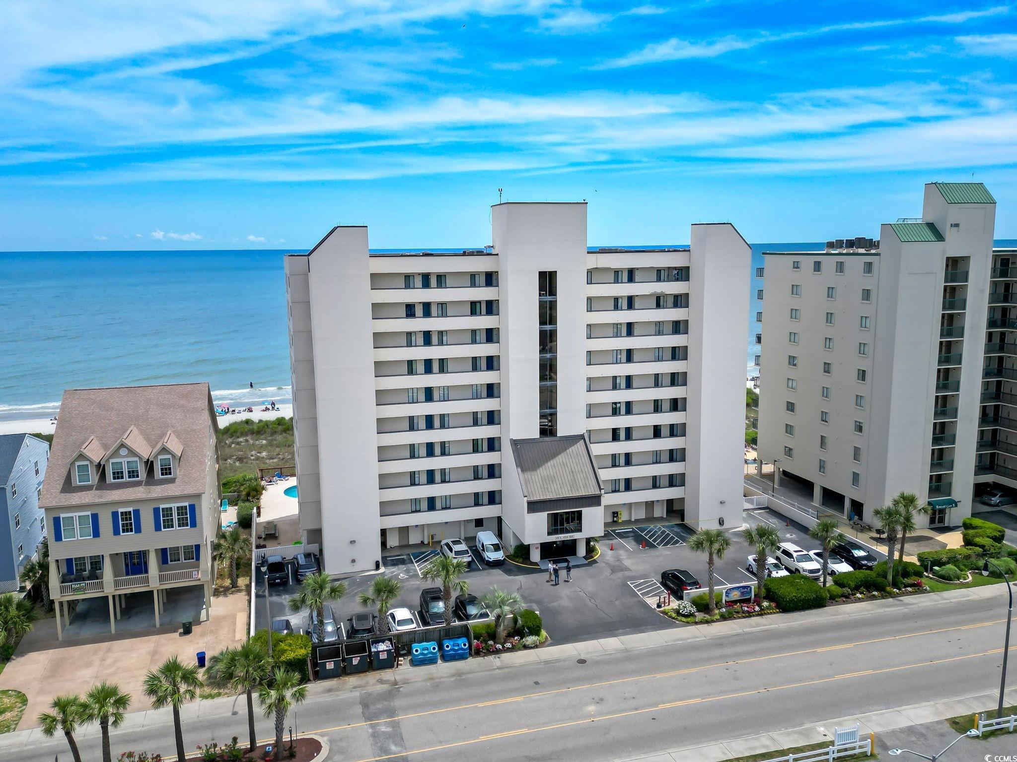 View of building exterior with a beach view and a