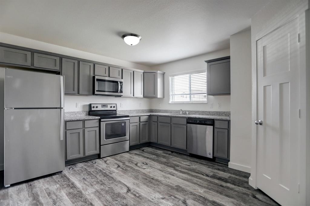 a kitchen with a refrigerator stove and microwave