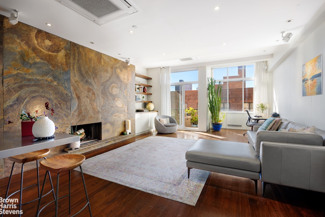 a living room with furniture a fireplace and a table