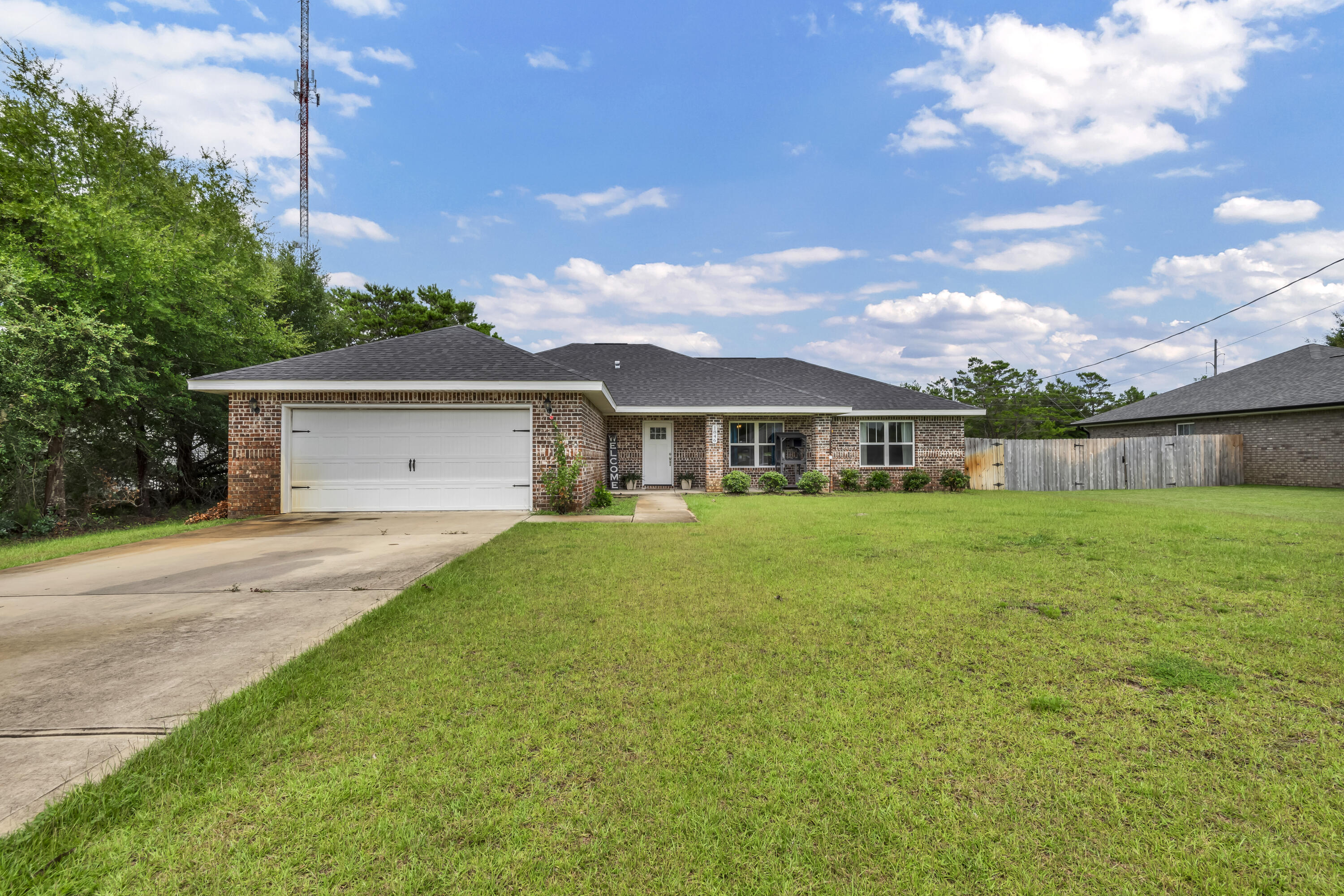 a front view of house with yard and green space