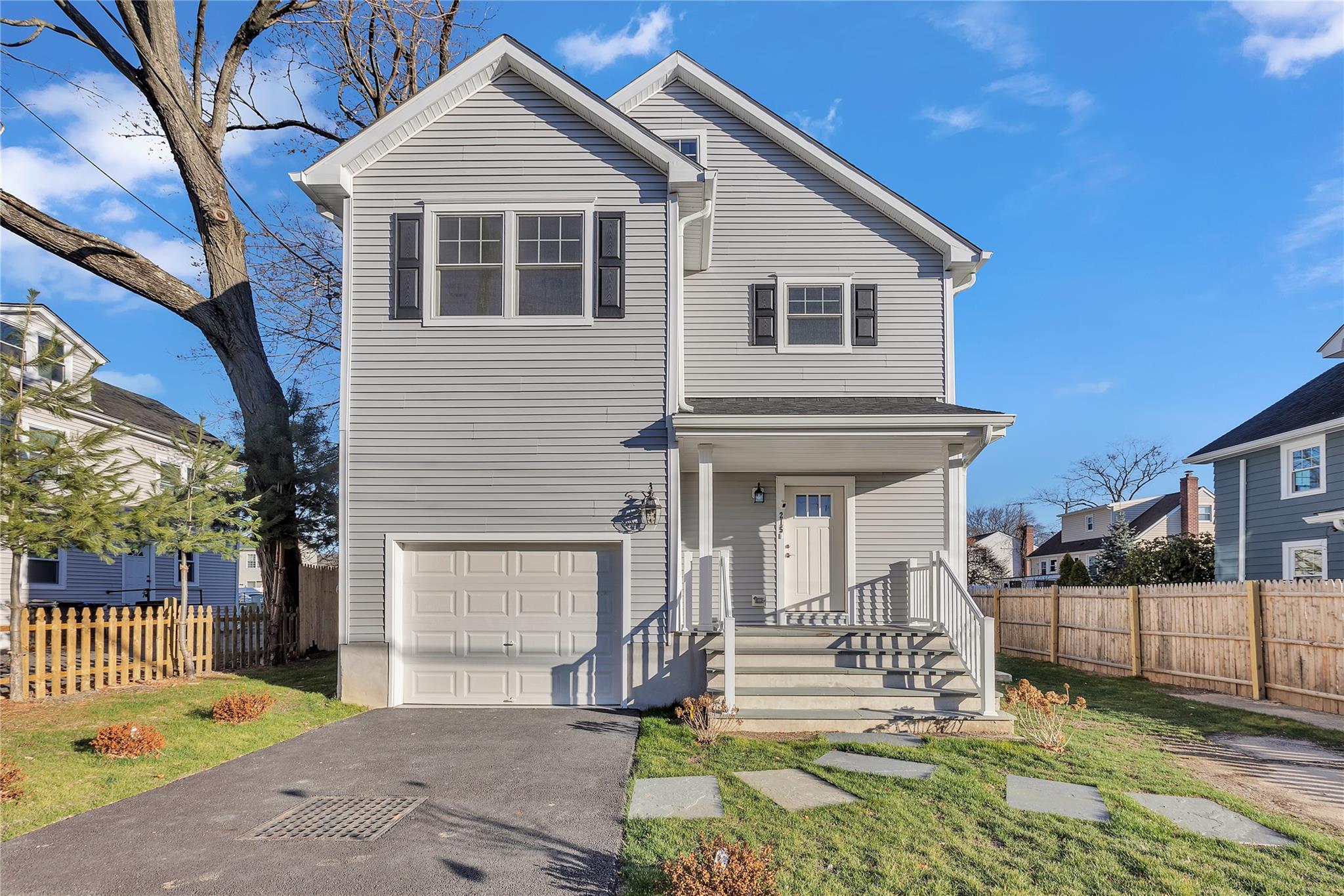 View of property with a garage and a front yard