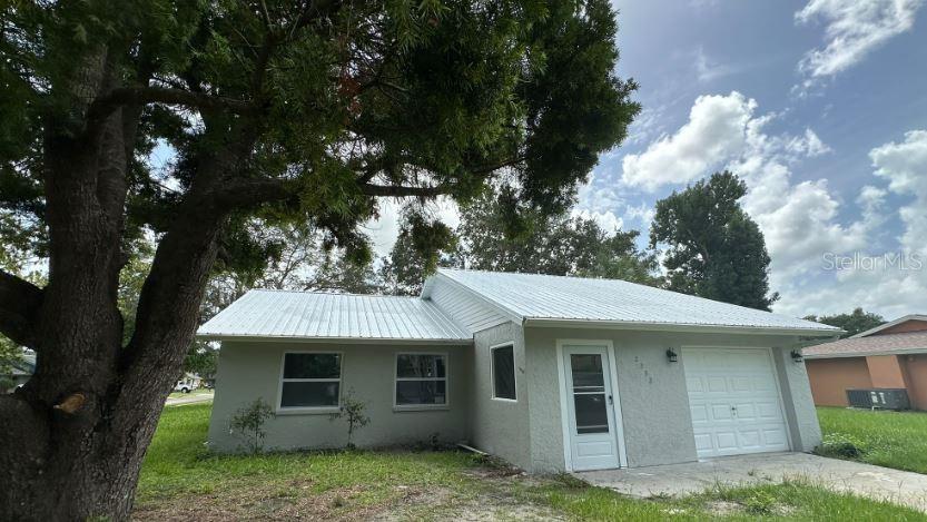 a view of a house with a tree