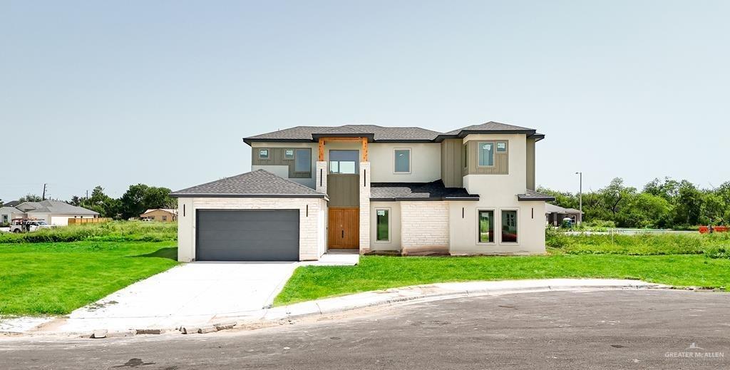 a front view of a house with a yard and garage