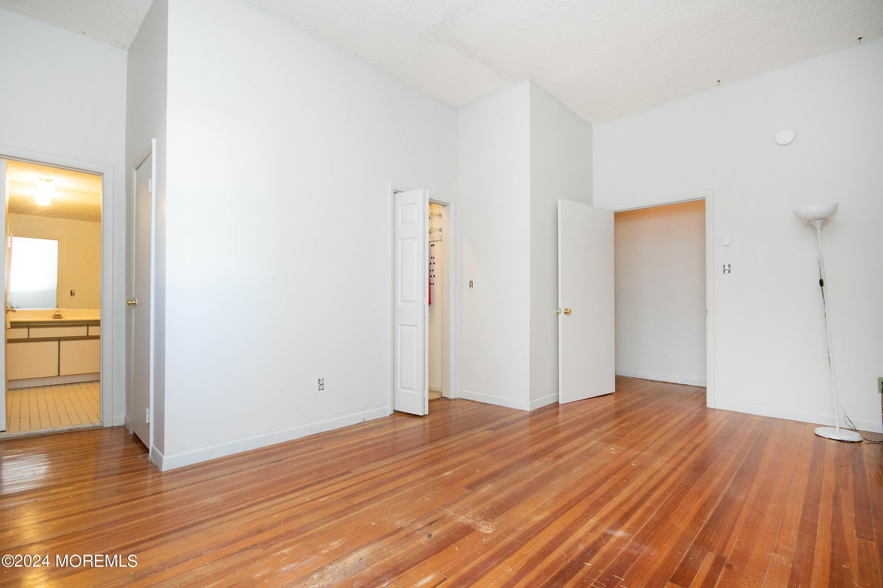 a view of a room with wooden floor