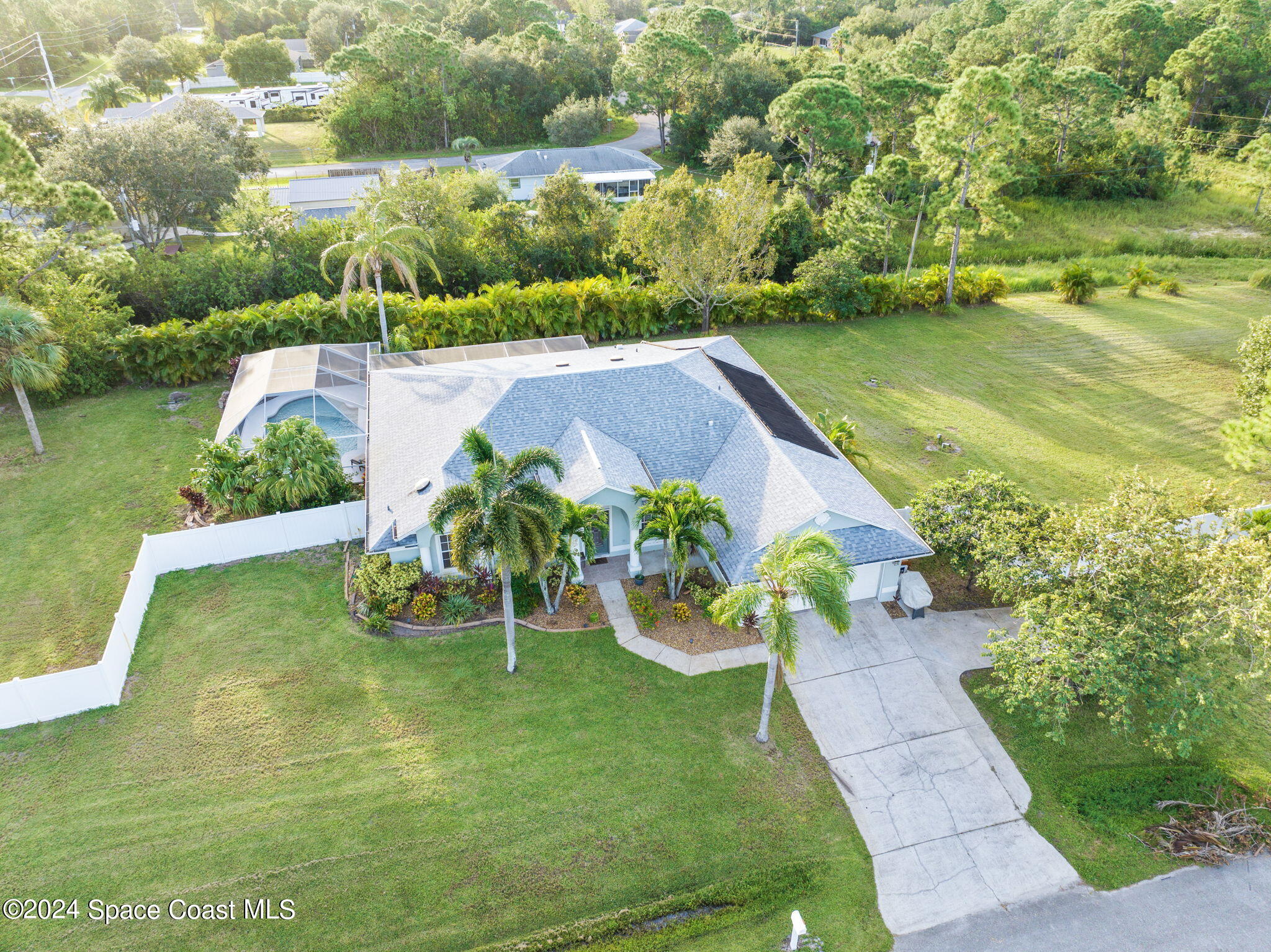 an aerial view of a house with yard swimming pool and outdoor seating