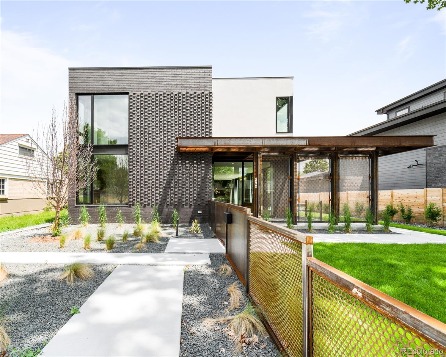 a view of a house with a yard and sitting area