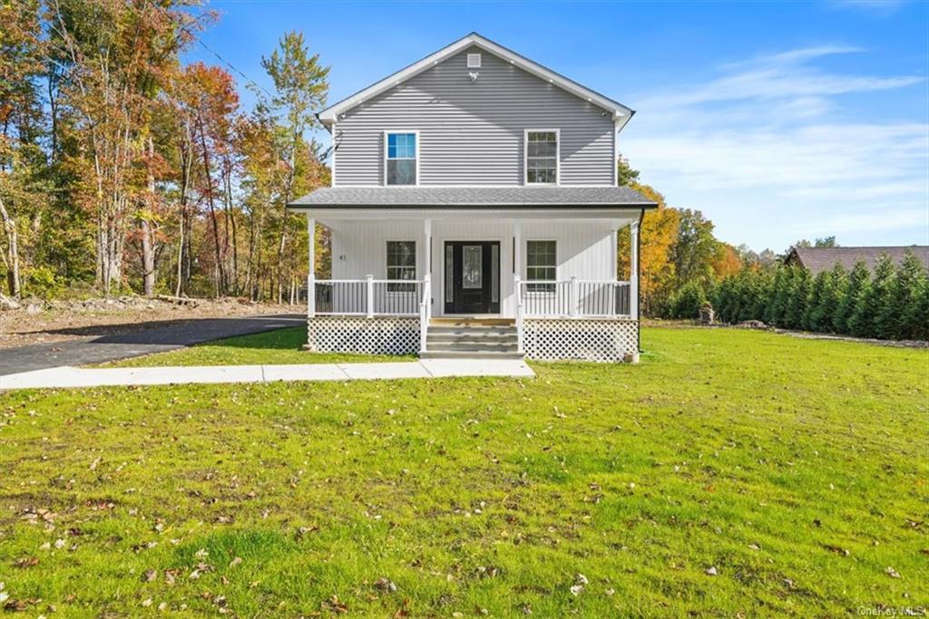 Front facade with a front yard and covered porch