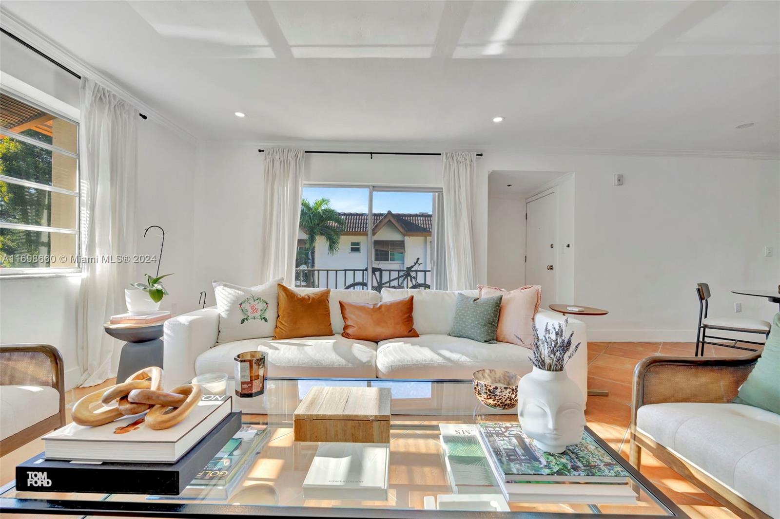 a living room with furniture a rug and a window