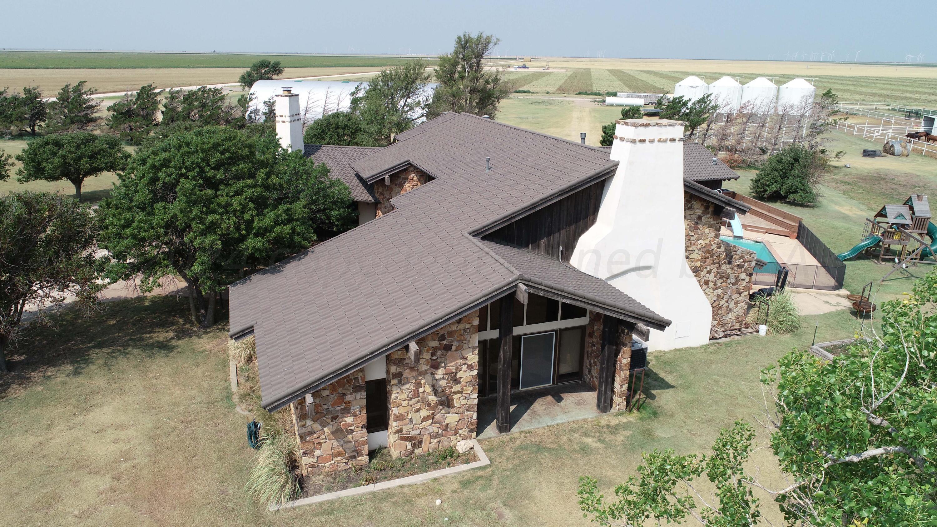 an aerial view of a house with large trees