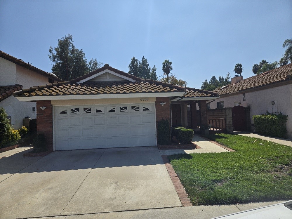 a view of a house with a yard and sitting area