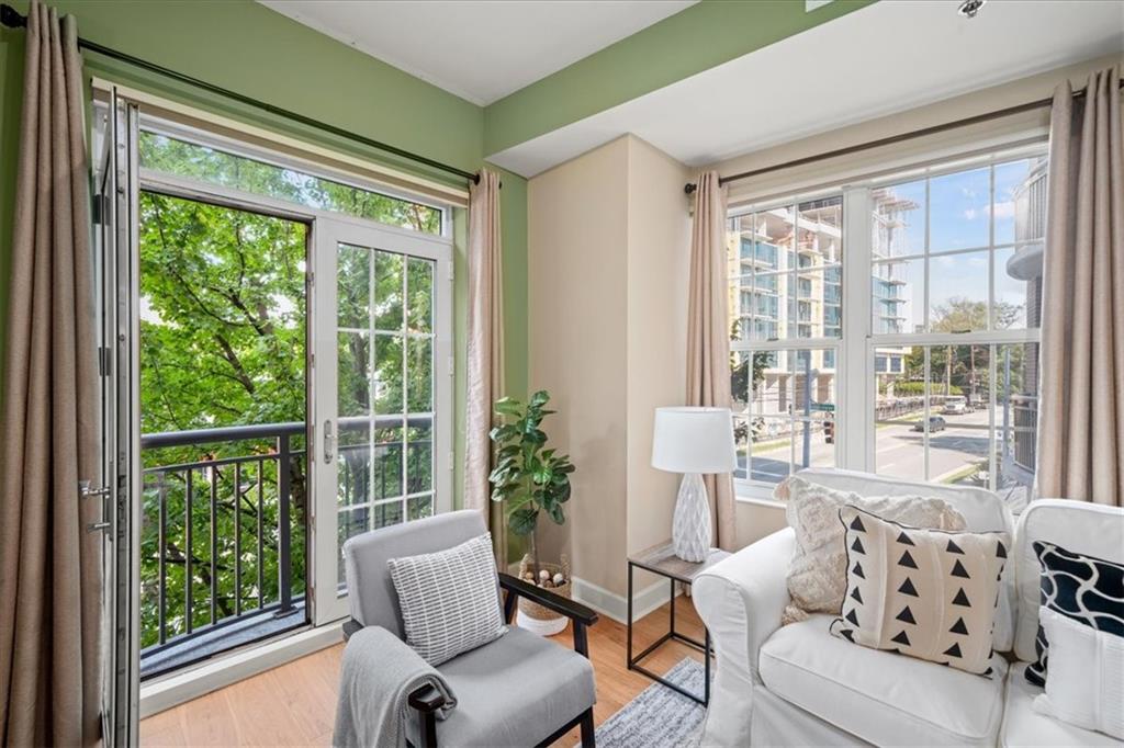 a living room with furniture and floor to ceiling windows