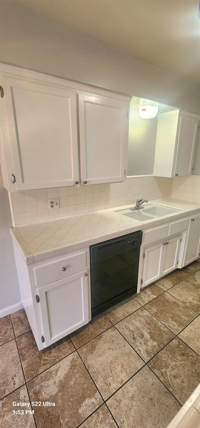 a bathroom with a sink vanity and mirror