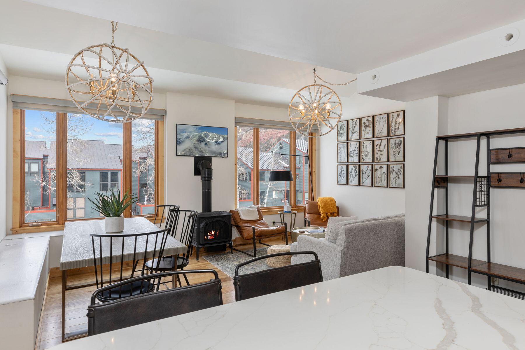 a living room with furniture chandelier and a large window