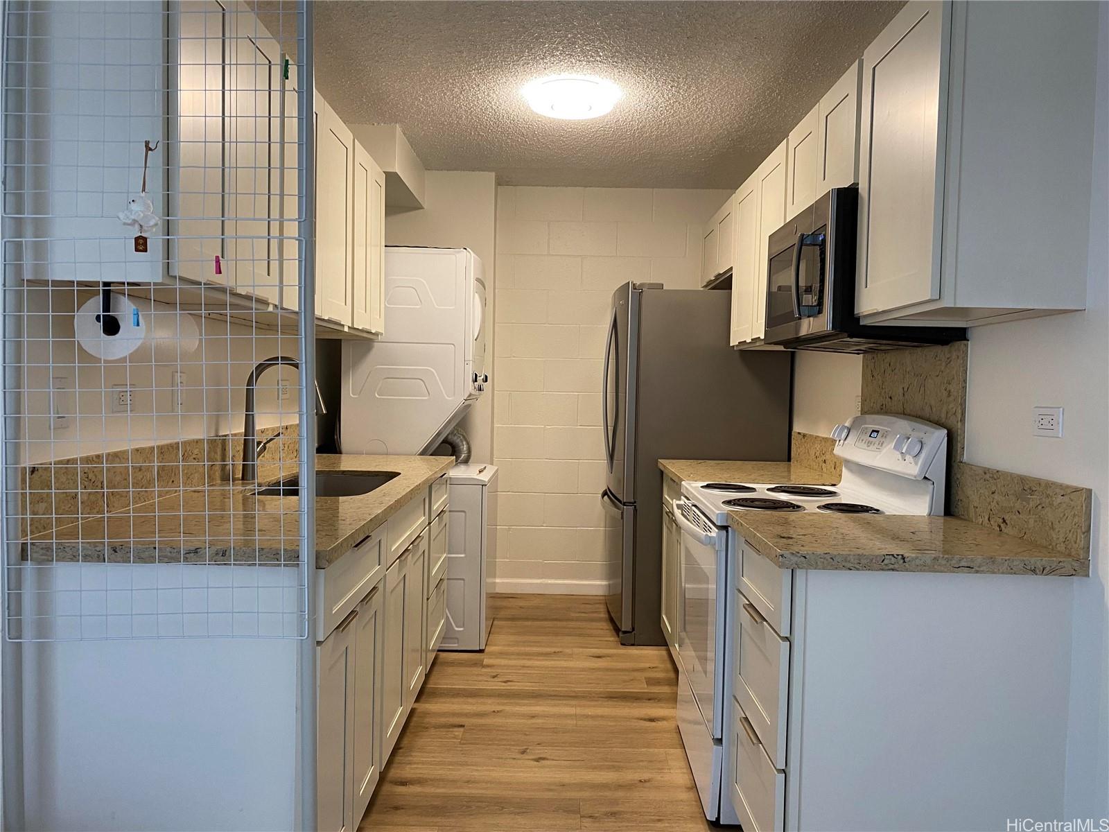 a kitchen with stainless steel appliances granite countertop a sink and a stove