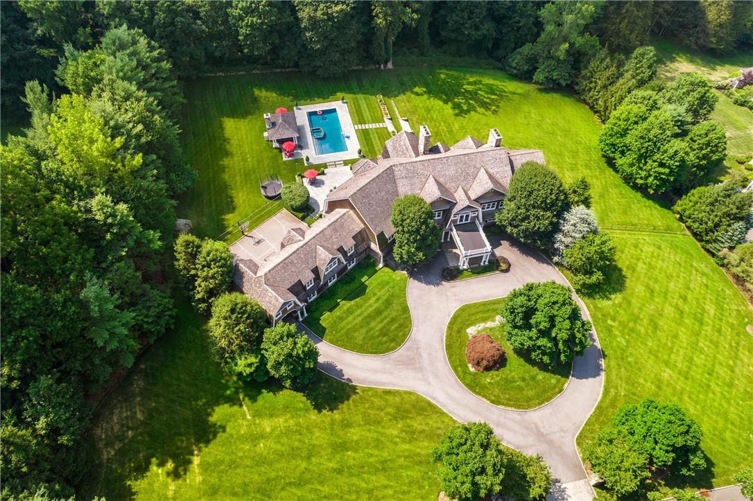 an aerial view of residential house with outdoor space and swimming pool