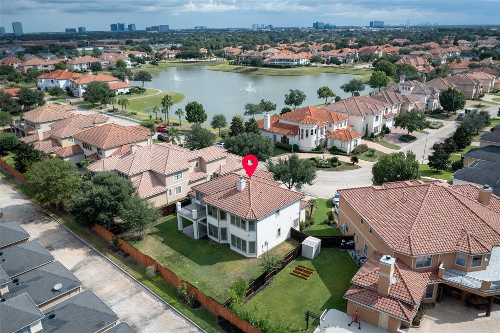 an aerial view of house with yard and lake view