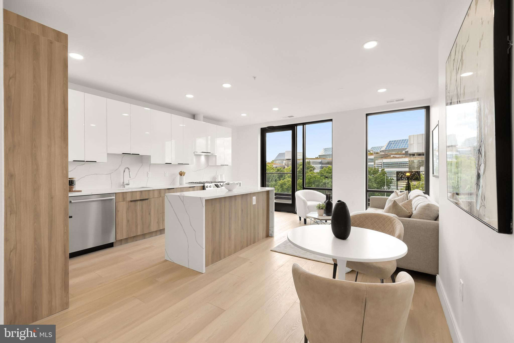 a living room with kitchen island furniture and a large window