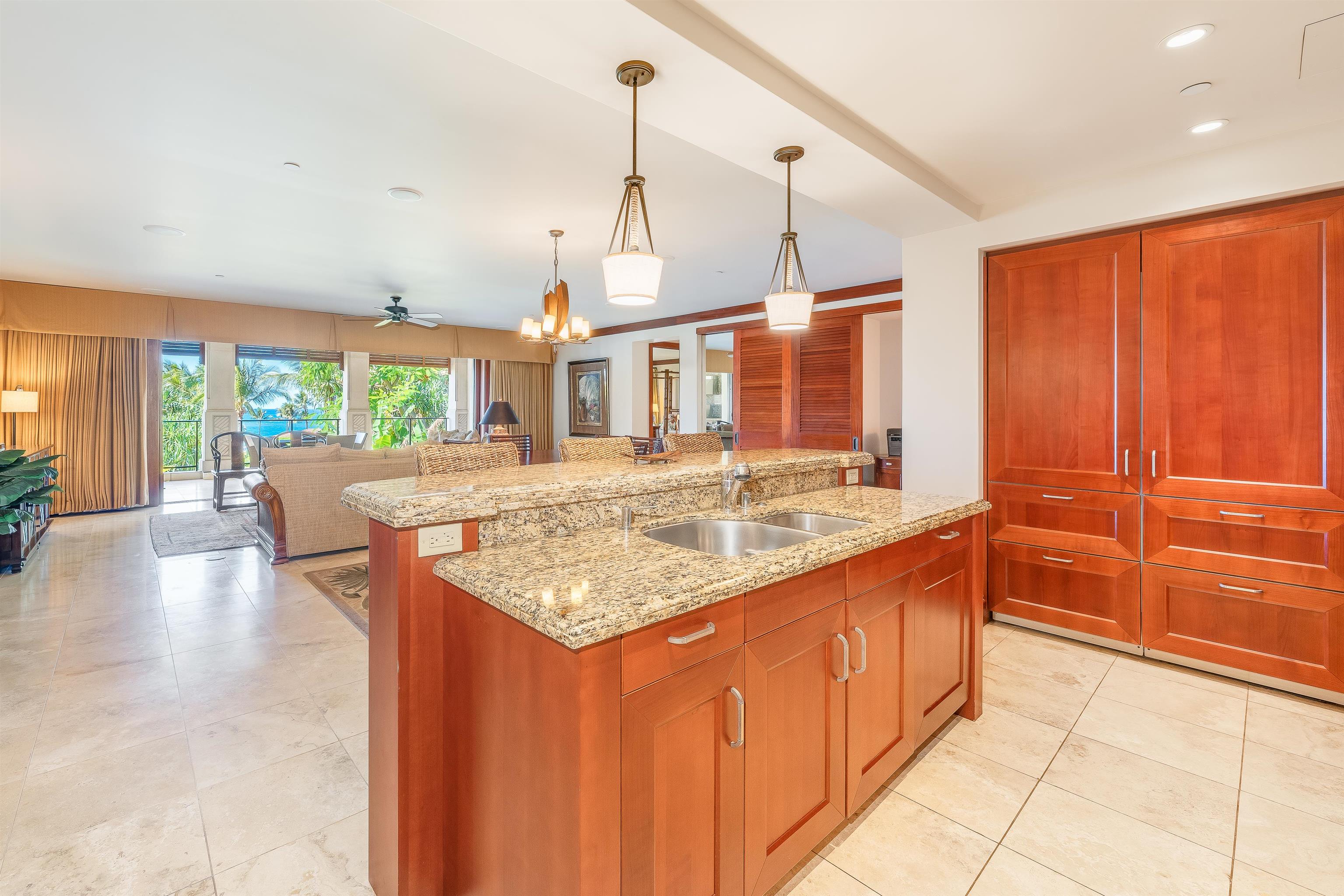 a kitchen with stainless steel appliances granite countertop a sink and a wooden cabinets