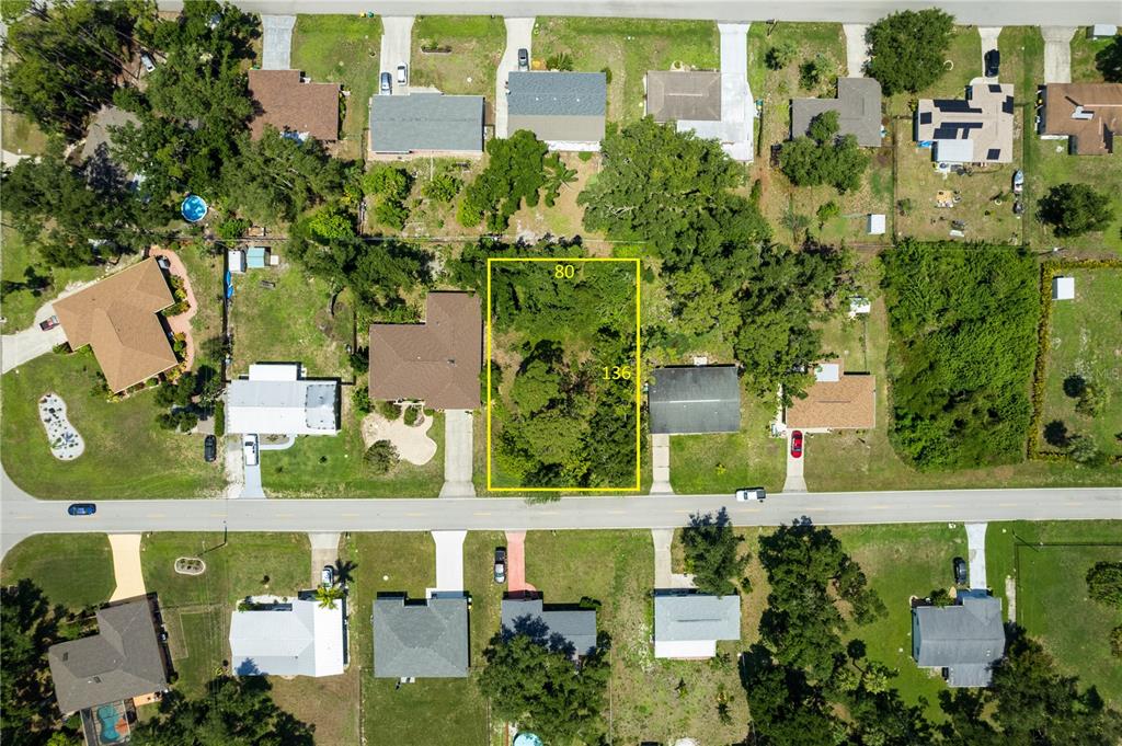 an aerial view of multiple houses with yard