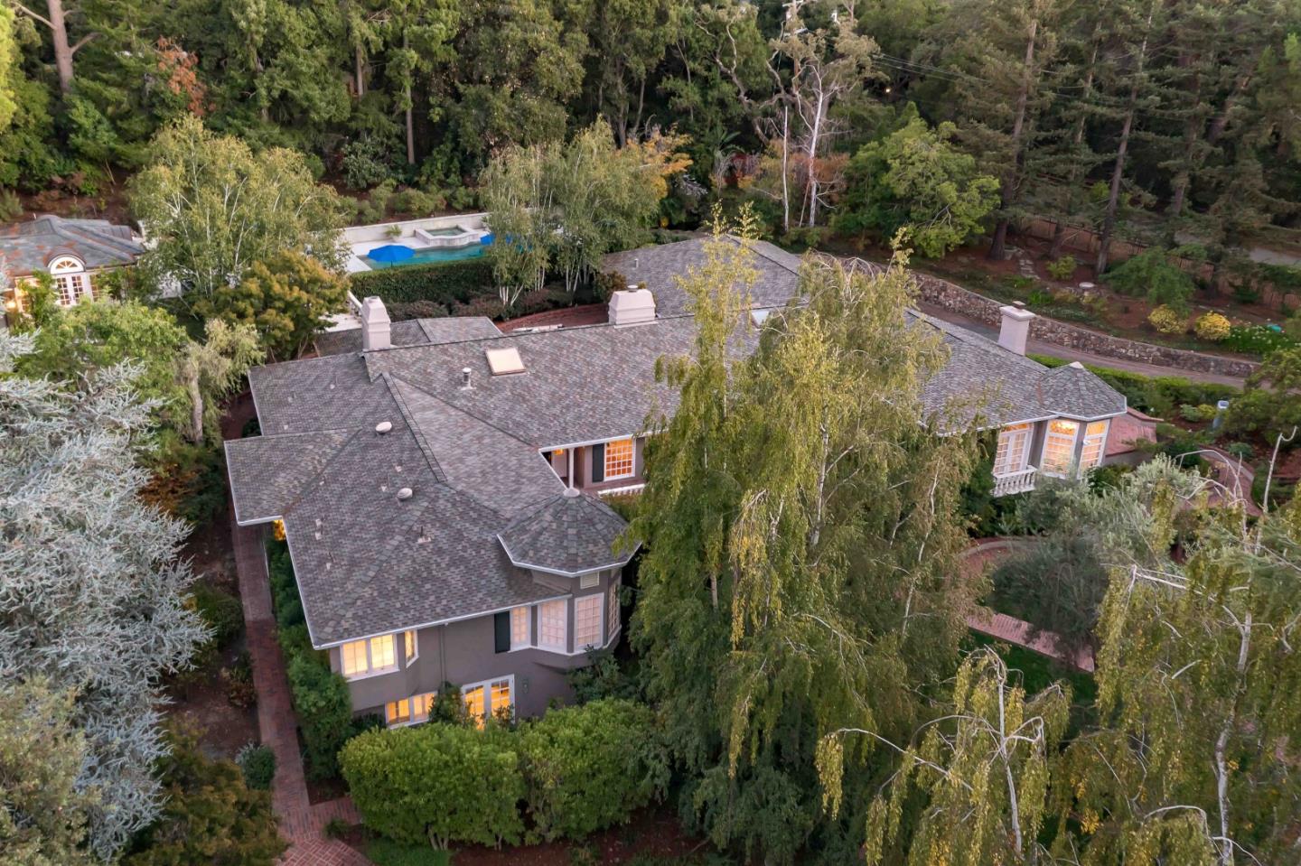 an aerial view of a house with yard and green space