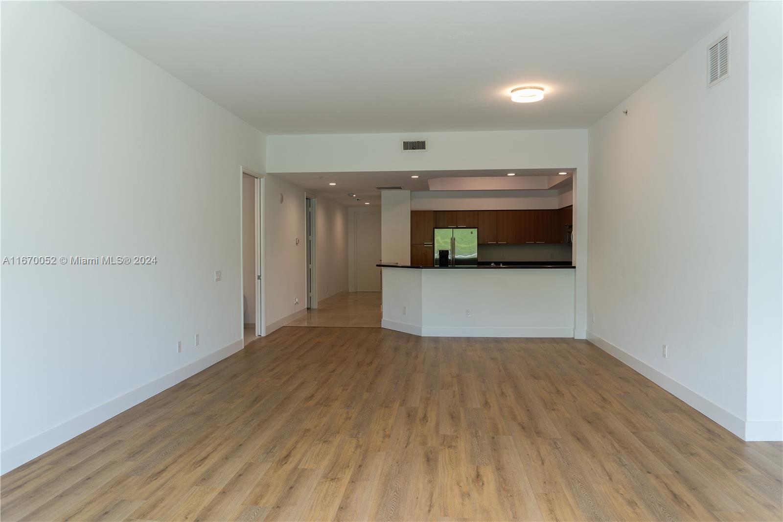 a view of a room with wooden floor and a fireplace