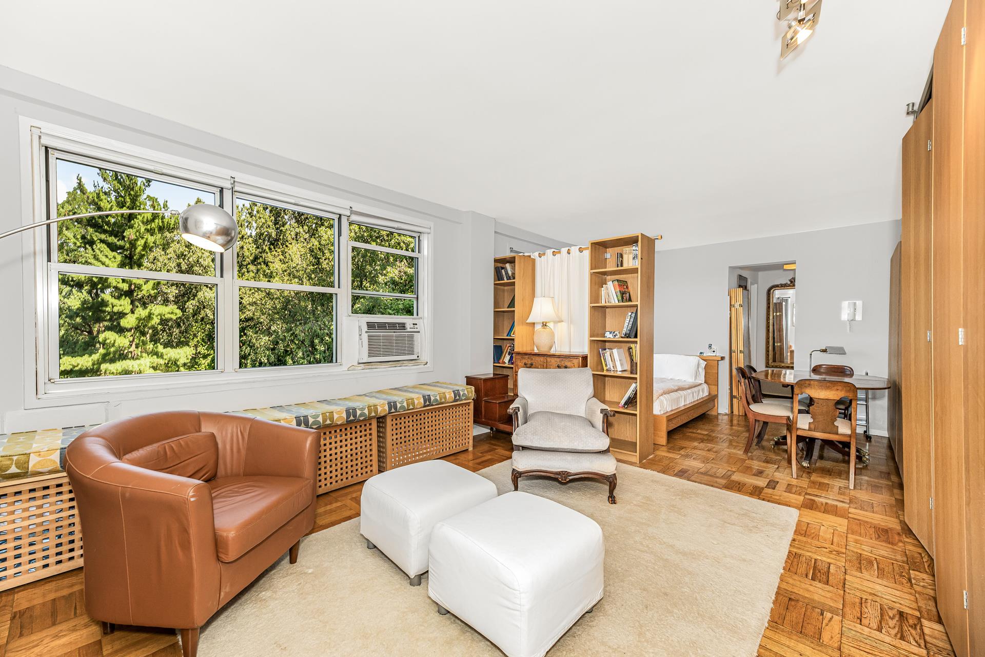 a living room with furniture and floor to ceiling windows