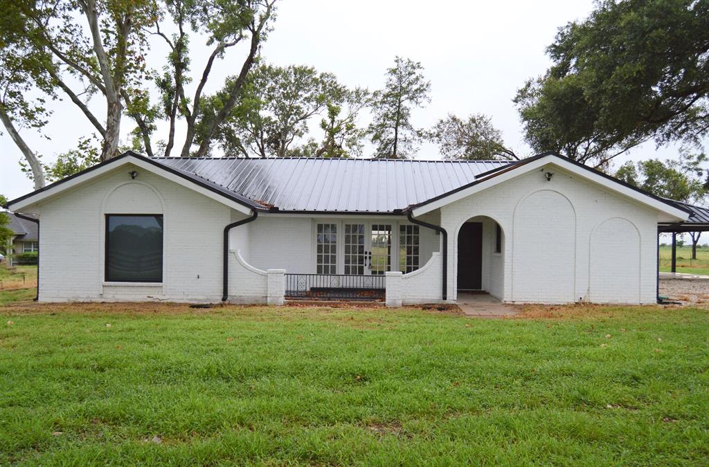 a view of house with backyard and garden