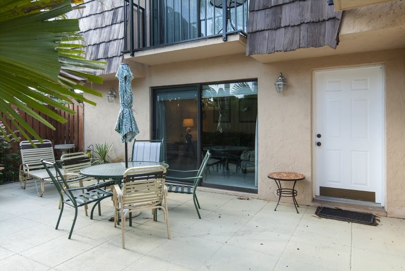 a building outdoor space with patio furniture and potted plants