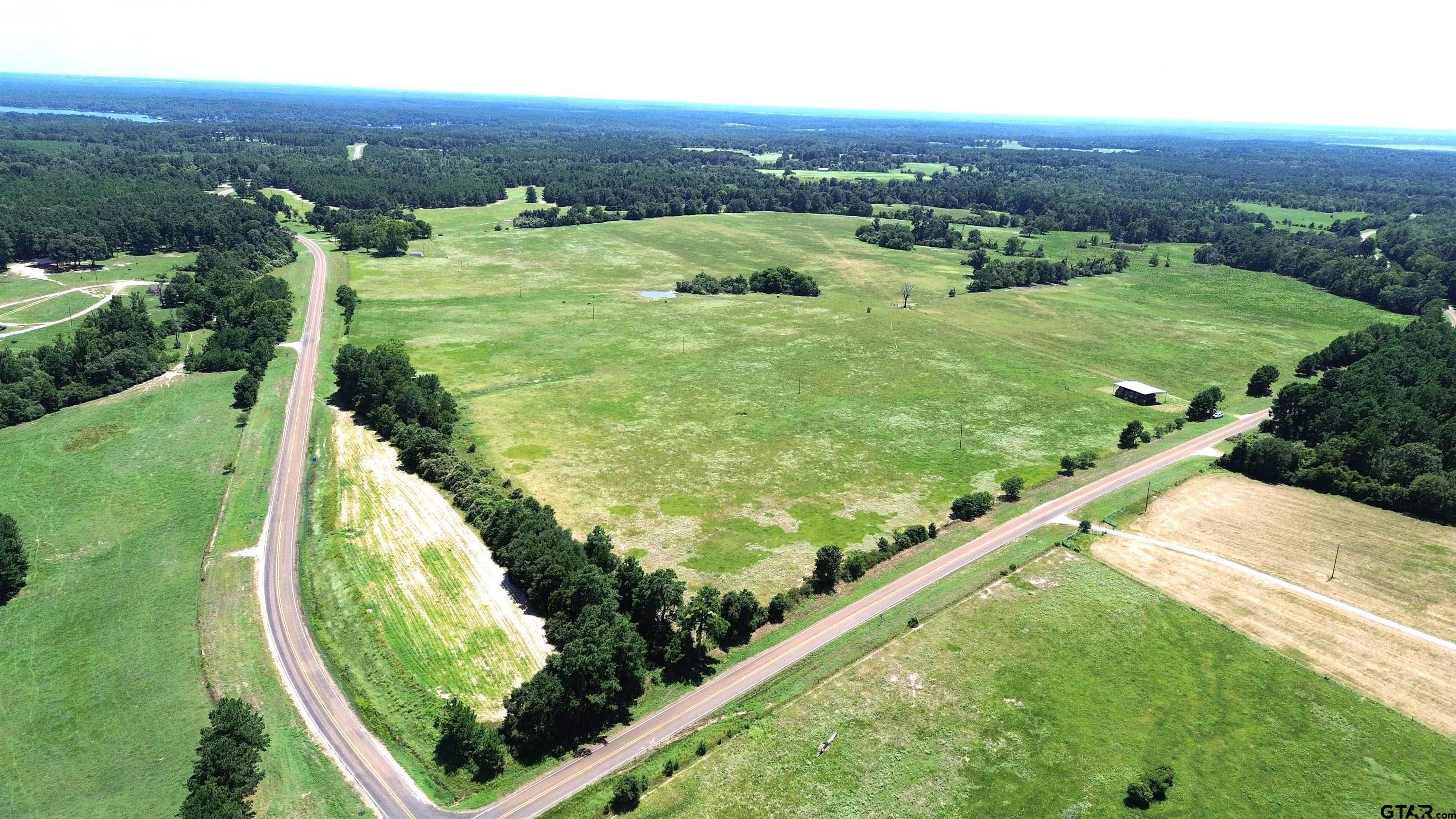 a view of a field with an ocean