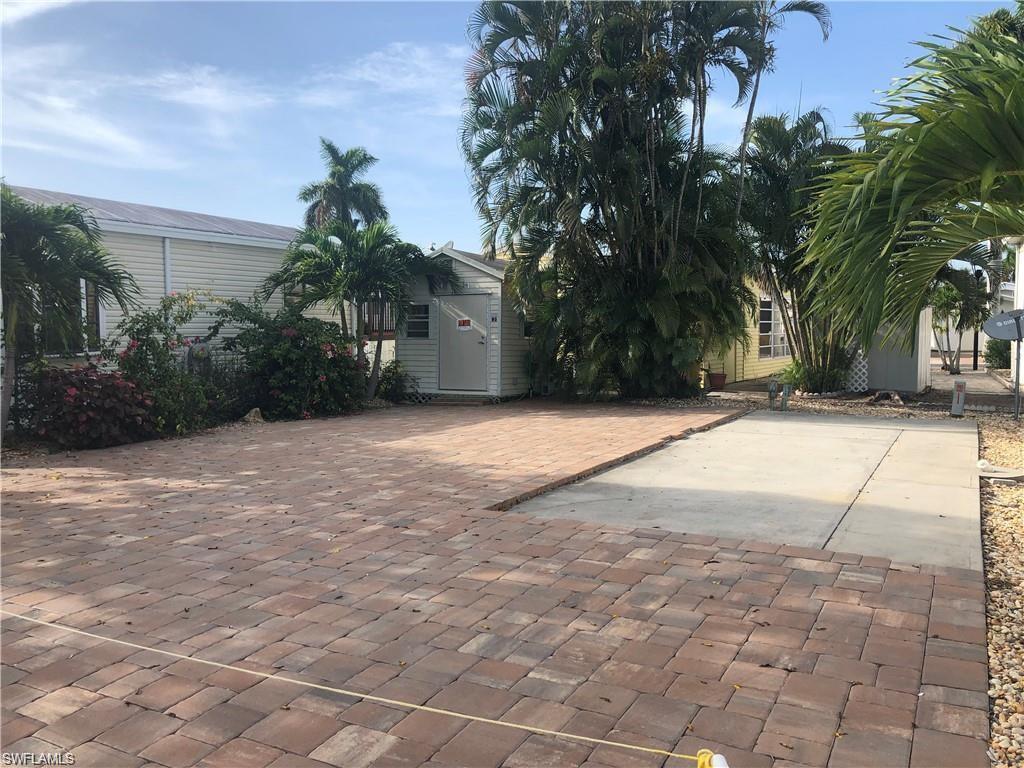 a view of a house with a yard and a garage