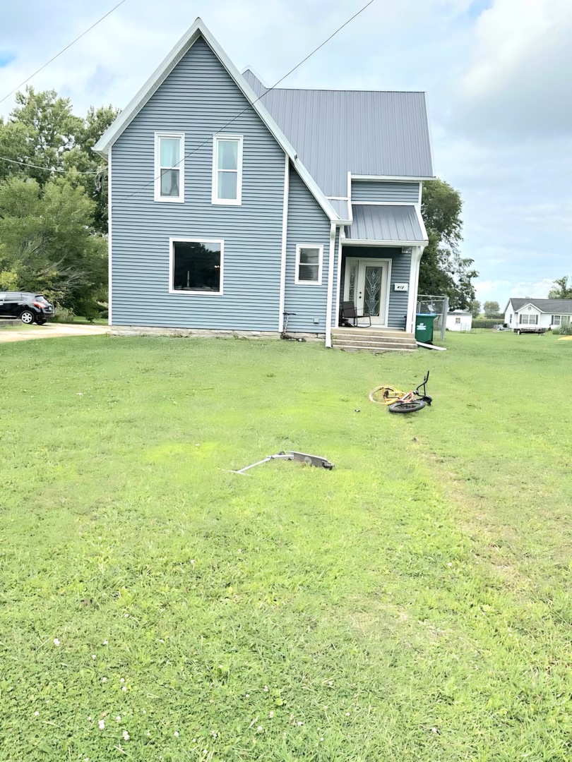 a front view of the house with garden