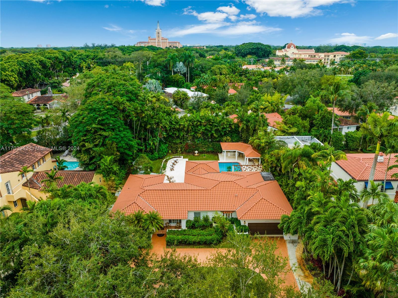 an aerial view of a house with yard swimming pool and outdoor seating