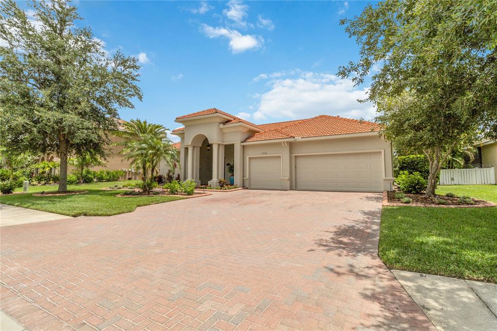  12428 Daisy Place Bradenton, FL 34212 in Greyhawk Landing. Long, wide, brick paver driveway, front brick curbing, elegant front porch, oversized  3 car garage, oversized lot.