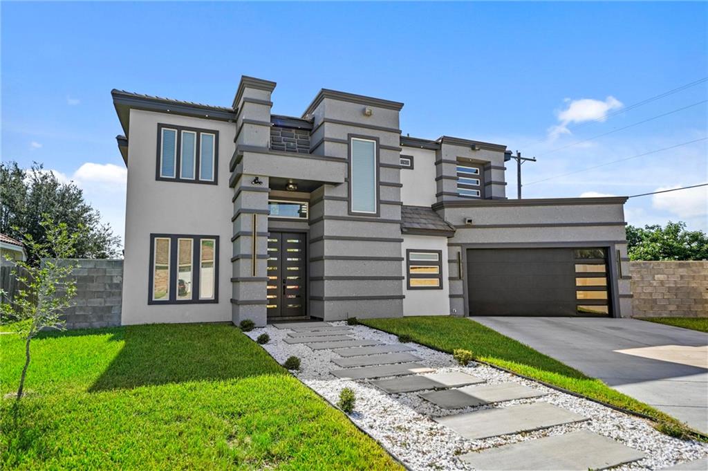 Contemporary house with a garage and a front yard