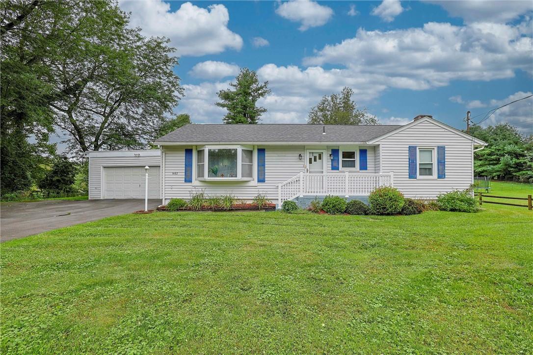 A single-story house with a front lawn and an attached garage.